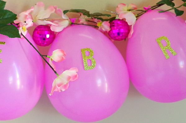 glitter letters on pink balloon garland